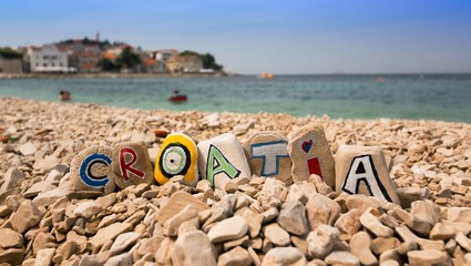 Croatia name on stones and dalmatian town - obrazy, fototapety, plakaty