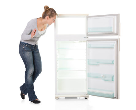 Young Woman Looking At Empty Refrigerator