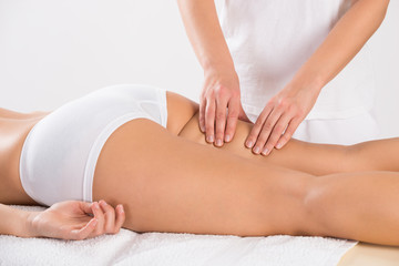 Obraz na płótnie Canvas Female Customer Receiving Leg Massage In Salon