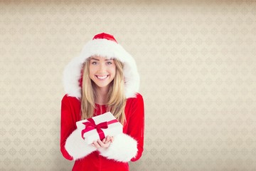 Composite image of sexy santa girl holding gift