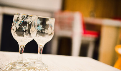 two empty christmas glasses on white table