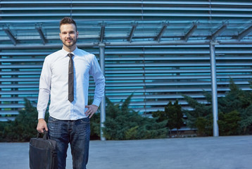 Friendly and smiling handsome businessman looking confidently at