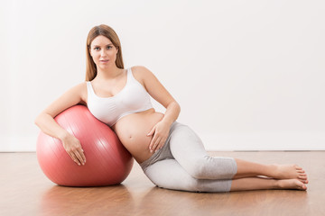 Pregnant woman exercising at home