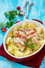 Baked potatoes with chicken and bacon in a rustic style