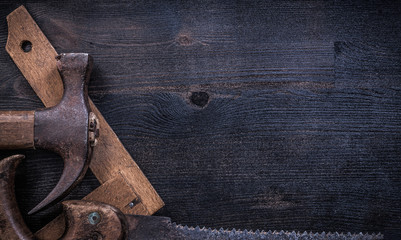 Collection of vintage rough construction tools on wooden board