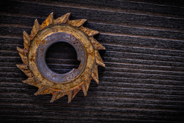Rusted sharp rotary cutter on vintage wood board construction co