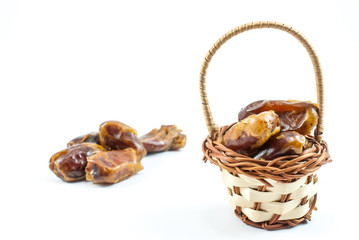Small basket with dates on white background