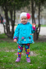 An outdoor portrait of a happy little girl on the park