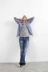 daydreaming 40s man with stretched arms behind his neck