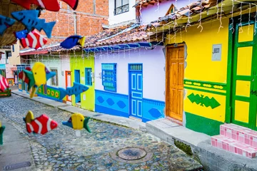 Fototapeten Beautiful and colorful streets in Guatape, known as town of Zocalos. Colombia © Fotos 593