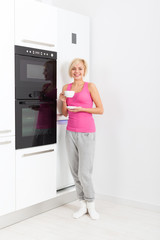 Fototapeta na wymiar young girl drink coffee, woman smile modern kitchen