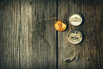 US cent coins over wooden background
