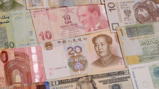 Various currency notes background. Dollar, Euro, Yuan, Lira, Kuna, Shekel and others. Dolly shot. 4K, UHD