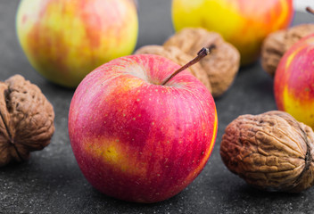 Still Life with apples and walnuts on a black background