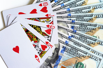 Fan-shaped playing cards of four suit, dollars and three dice