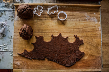 Cutting out gingerbread dough. Traditional Christmas sweet cakes / cookies