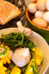 baskets of eggs, bread, squash, garlic and orange