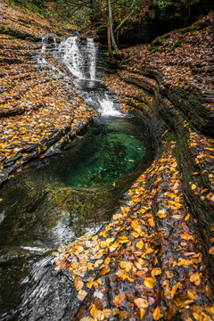 Devils bathtub located in the Blue Ridge Mountains of Virginia is an amazing rare pool of crystal clear blue water below this cascade. 
