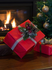 Red Christmas Presents With Holiday Decorations and Fireplace in Background