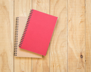 Top view of red and brown book on wooden table