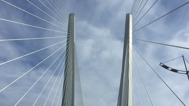 Trip across large, cable stayed bridge on  machine.