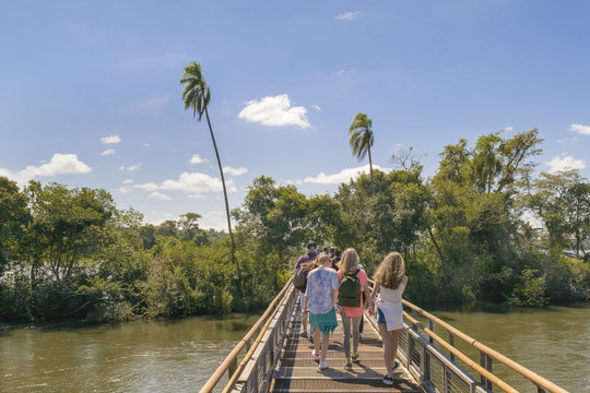 PORT IGUAZU, ARGENTINA, MARCH - 2015 - Tourists crossing the bridge which goes to devil throat falls at Iguazu park at argentinian border.