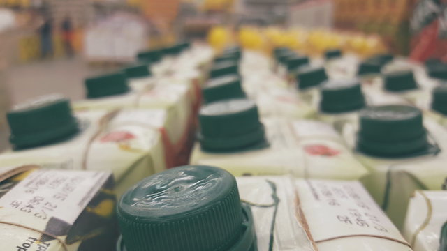 Packages with juice in a supermarket with a blurred background