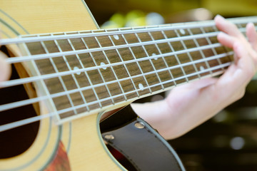 Fototapeta premium guitar player,Close up image of Musicians are playing on his acoustic bass guitars. 
