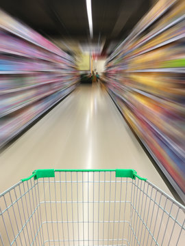 supermarket shopping cart view with supermarket aisle motion blu