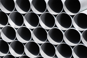 stacking steel pipe at construction site