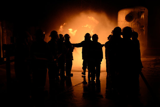 Firefighters training fighter at night.