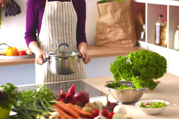 Young Woman Cooking in the kitchen. Healthy Food