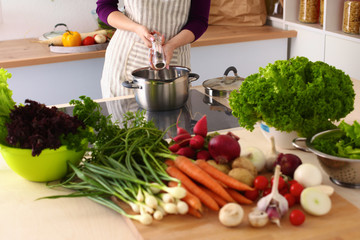 Young Woman Cooking in the kitchen. Healthy Food