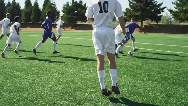 A soccer player shoots a goal during a game and misses
