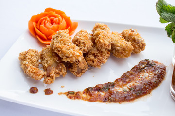 Tasty fried chicken  and vegetable in white plates on white back