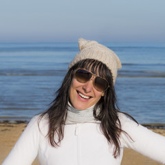 Happy middle-aged woman smiling at the beach 