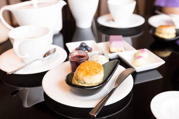Scone with jam and butter for afternoon tea