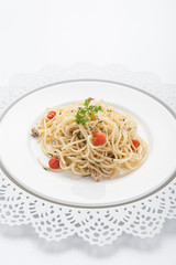 Spaghetti pasta with cherry tomatoes, basil and parmesan cheese, selective focus