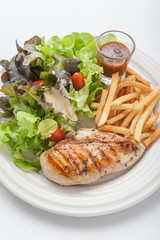 Chicken steak served with french fries and salads to vegetables.