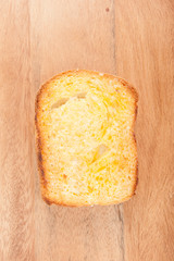toasted bread with honey on wood table still life