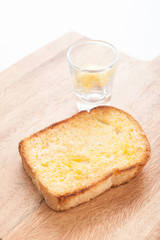 toasted bread with honey on wood table still life