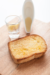 toasted bread with honey on wood table still life