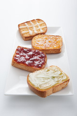 Mix fruit, blueberry, orange fruit jam spread on bread toast ove