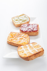 Mix fruit, blueberry, orange fruit jam spread on bread toast ove
