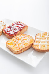 Mix fruit, blueberry, orange fruit jam spread on bread toast ove