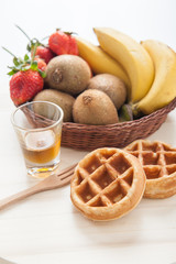 Waffles with mixed fruit and maple syrup