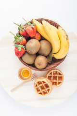 Waffles with mixed fruit and maple syrup