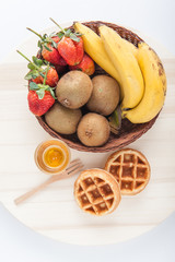 Waffles with mixed fruit and maple syrup