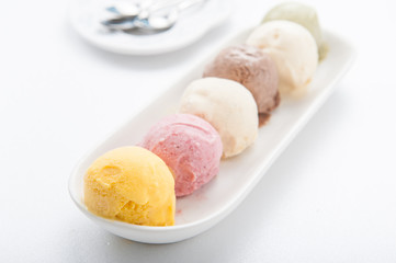 Mixed ice creams in bowl on white background