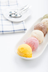 Mixed ice creams in bowl on white background